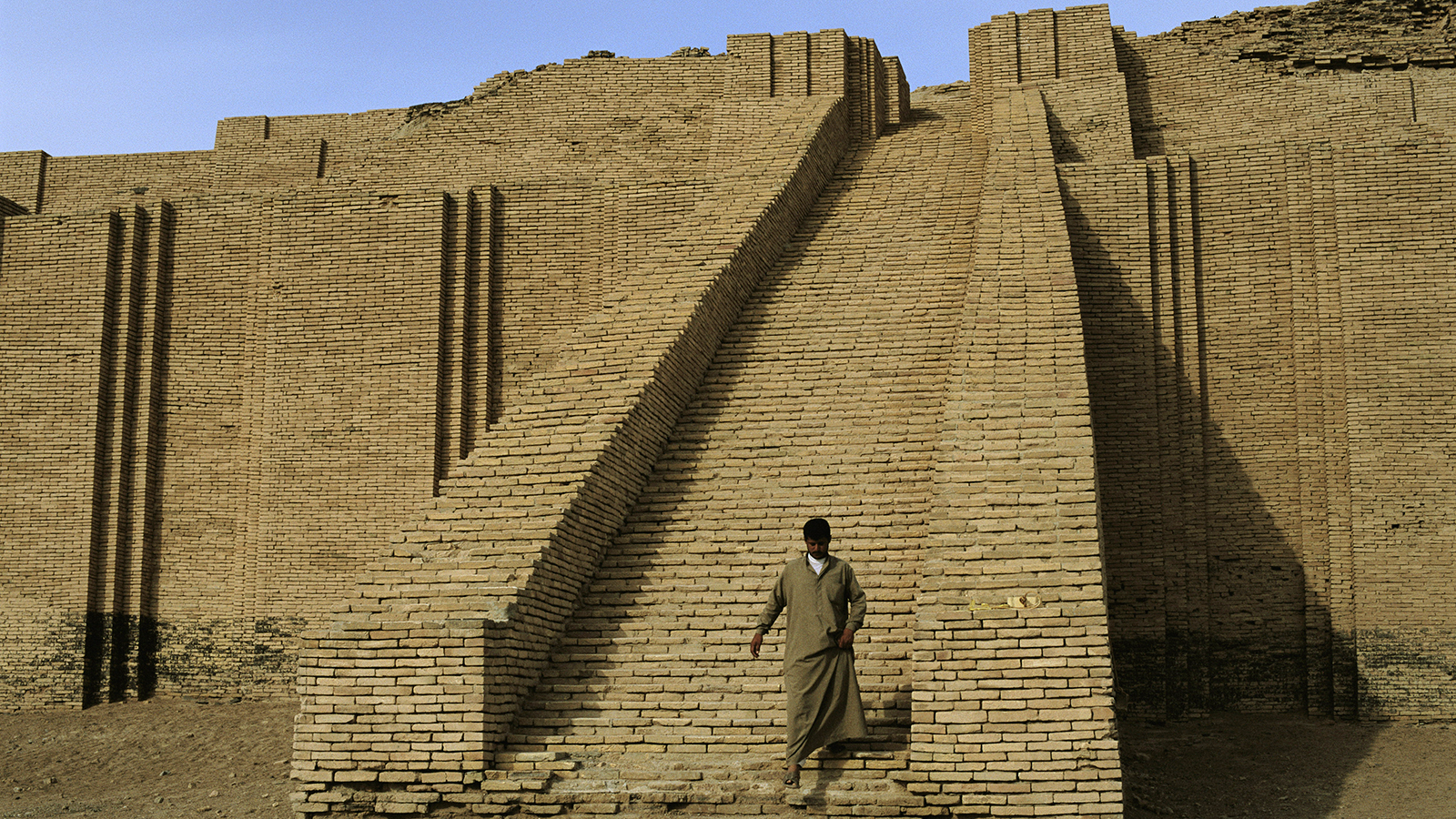 Man walks down the steps of the 4,000 year old Ur ziggurat.