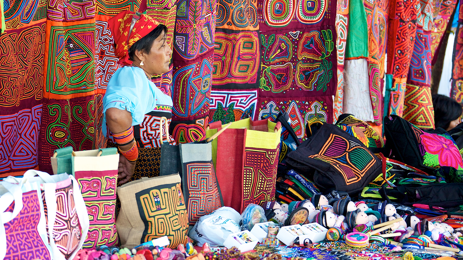PANAMA CITY, PANAMA - JANUARY 18, 2014: A Kuna woman selling molas in an open air market in Panama City. The Kuna people, also known as Guna, are indigenous people of Panama and Colombia. ; Shutterstock ID 180144593; PO: BB: Country Photos for Website