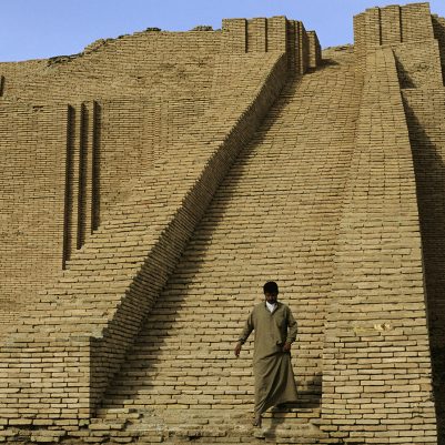 Man walks down the steps of the 4,000 year old Ur ziggurat.